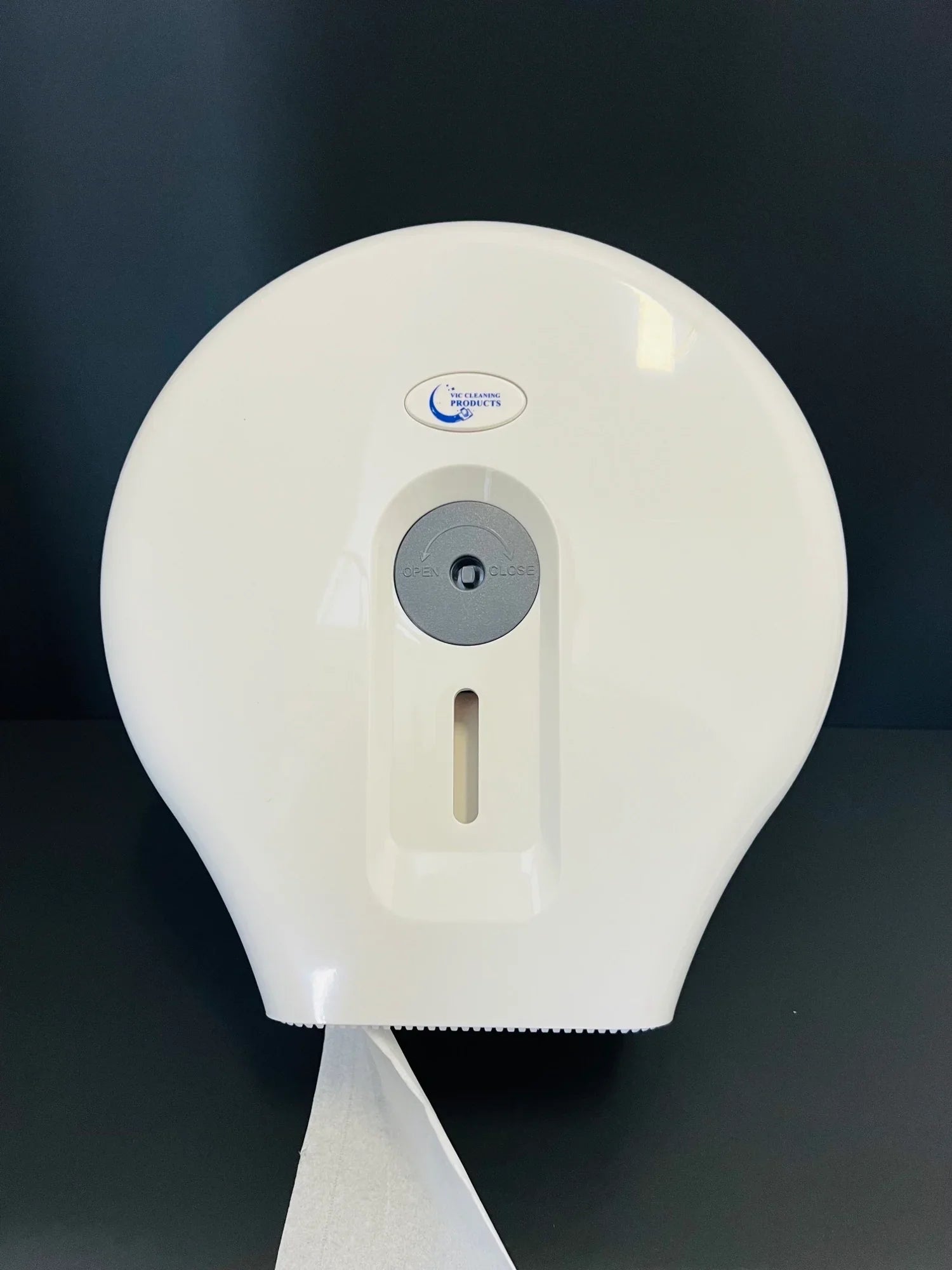 Wall-mounted white jumbo toilet paper dispenser with paper roll, for commercial bathrooms