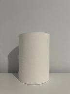 White textured paper towel roll on a plain surface for cleaning or kitchen use